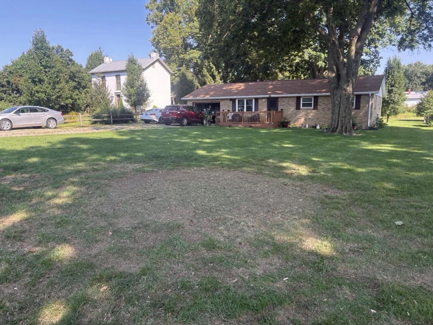 The same residential lawn after stump grinding, with the visible stump removed