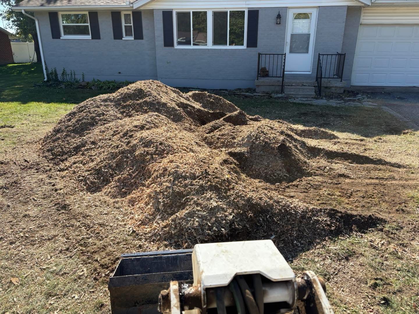 Worley's crew working through a shrub bed during a residential cleanup